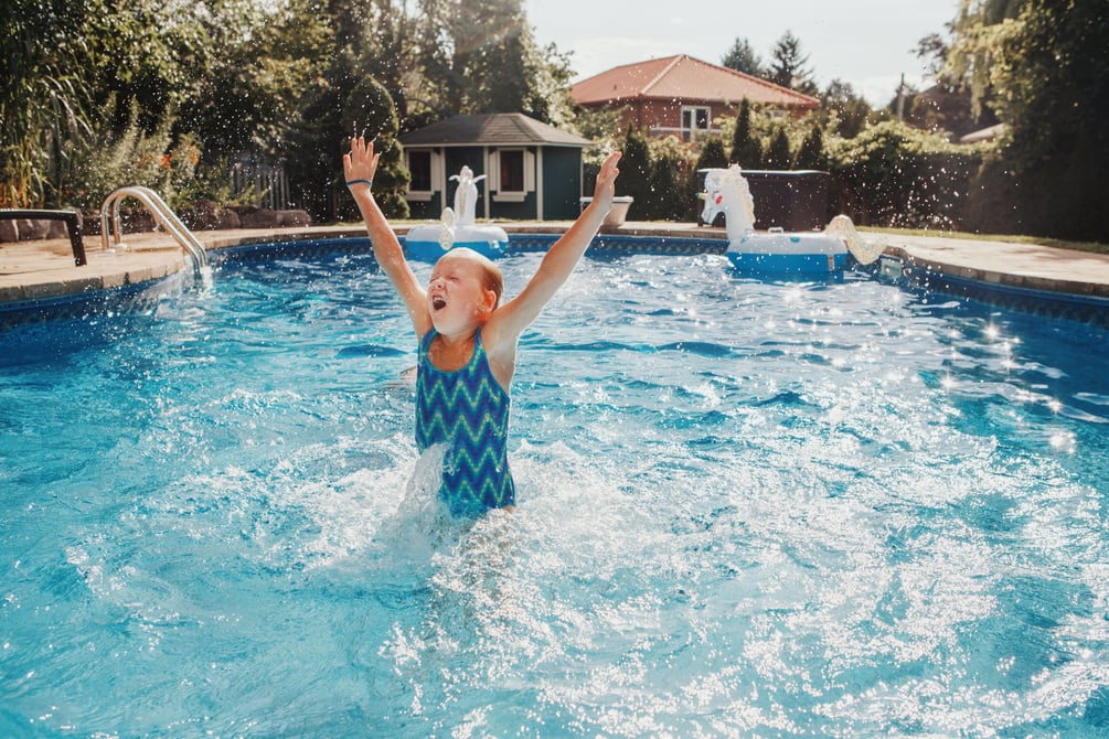 Girl Swimming in Pool on Home Backyard