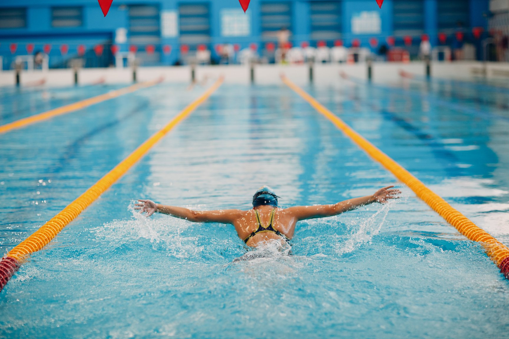 Swimmer Swims in Swimming Pool